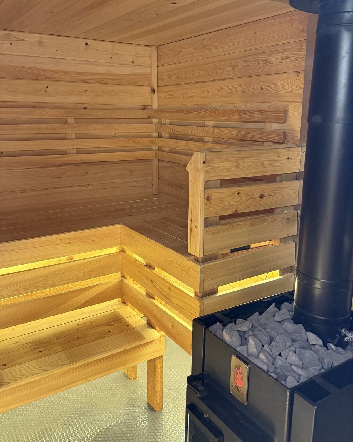 Corner bench beside the stove guard inside the sauna