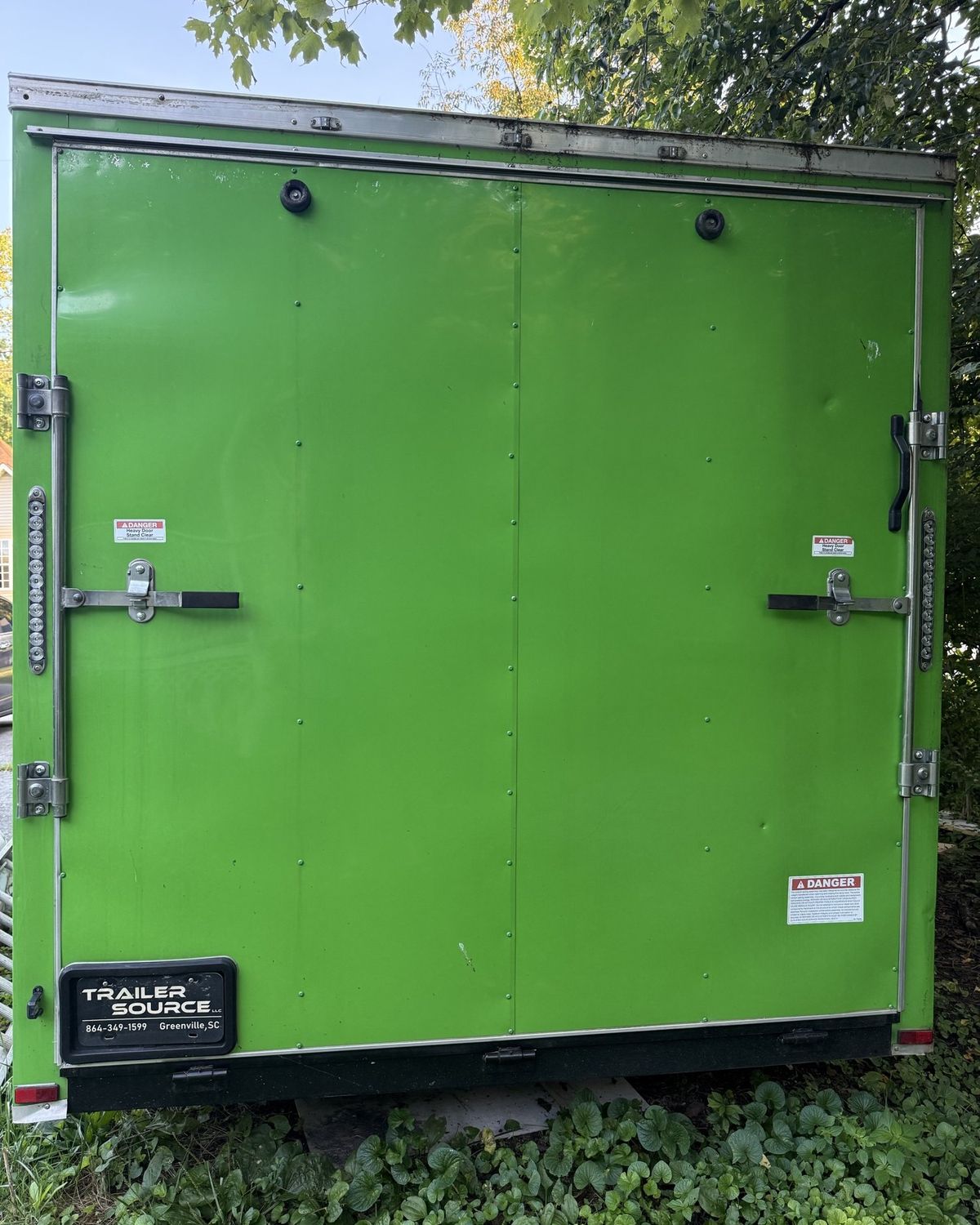 Rear doors of the green Smoky Banya sauna trailer